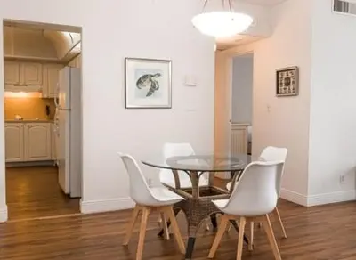a dining room with a glass table and white chairs at Komffy Apt w/2 Queen Beds & Canal View at Tides in Hollywood
