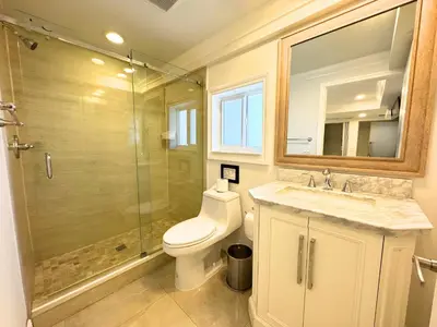 a bathroom with a toilet and a shower and a sink at Spacious 4/4 Home Central To All Attractions in Hollywood