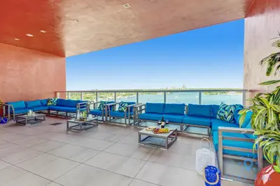 a large room with blue couches and tables at Studio - Steps from Hollywood Boardwalk in Hollywood