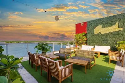 a patio with tables and chairs and a view of the water at Studio - Steps from Hollywood Boardwalk in Hollywood