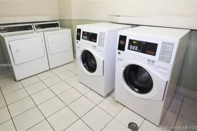 two washing machines and a washer and dryer in a kitchen at PROMO Komffy Home with King Bed & Ocean View at Tides 7th floor in Hollywood