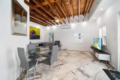 a dining room with a glass table and chairs at Waterside Escape w/Queen Bed & Free Parking in Hollywood