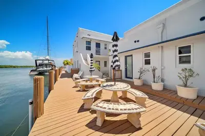 a wooden deck with benches and tables and a boat at Waterside Escape w/Queen Bed & Free Parking in Hollywood