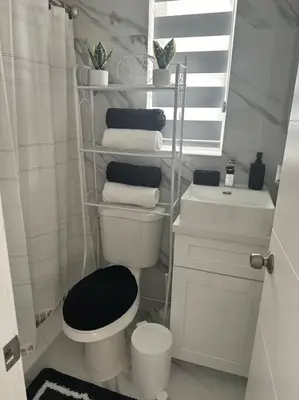 a white bathroom with a toilet and a sink at VillaClara Studio-Little Havana in Miami