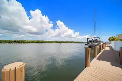 a boat is docked at a dock on the water at Komffy Intercoastal retreat King Bed, Free Parking in Hollywood