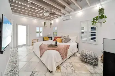 a white bedroom with a large bed and a television at Komffy Studio with King Bed in Hollywood