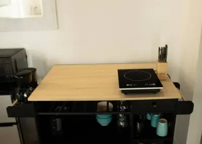 a wooden table with a counter top with a stove at Komffy Studio with King Bed in Hollywood