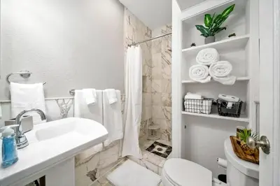 a white bathroom with a toilet and a sink at Komffy Studio with King Bed in Hollywood