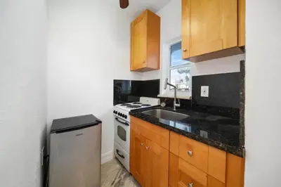 a small kitchen with a sink and a stove at Waterside Studio w/ King bed - Hollywood in Hollywood