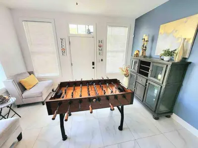 a ping pong table in a living room at Brickell + Wynwood Wonderland: Spacious 6BR Home in Miami