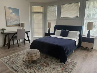 a bedroom with a bed and a table and a desk at Brickell + Wynwood Wonderland: Spacious 6BR Home in Miami