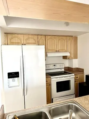 a kitchen with a white refrigerator and a sink at Private bedroom 1 block from Downtown Miami in Miami