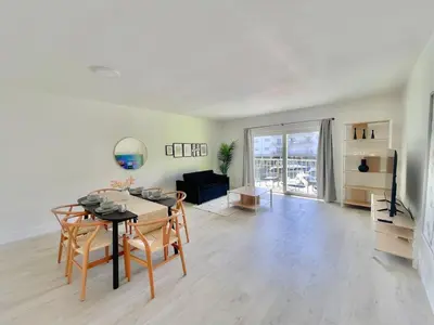 a dining room with a table and chairs in a living room at 1BR with Kitchen Close To Sunny Isles Beach in North Miami Beach