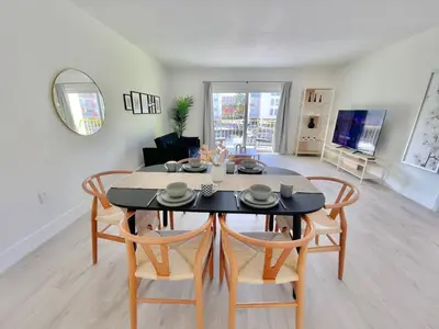 a dining room and living room with a table and chairs at 1BR with Kitchen Close To Sunny Isles Beach in North Miami Beach