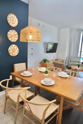 a dining room with a wooden table and chairs at 2BR-2BA Oasis W-Stunning Views at Beachwalk in Hallandale Beach