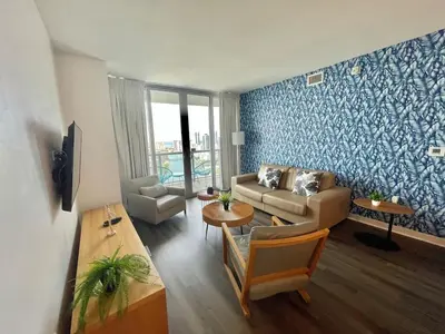 a living room with a couch and a table at 2BR-2BA Oasis W-Stunning Views at Beachwalk in Hallandale Beach