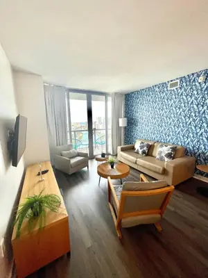 a living room with a couch and a table at Beachwalk -1 Bedroom W-Kitchen and Great Views in Hallandale Beach