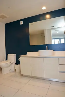 a bathroom with a sink and a toilet and a mirror at Beachwalk -1 Bedroom W-Kitchen and Great Views in Hallandale Beach