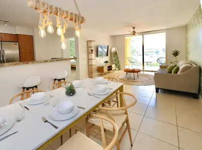 a kitchen and living room with a table and chairs at 2 Luxury Bedrooms at Yacht Club de Aventura in Miami