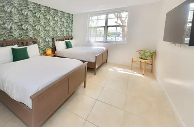 a bedroom with two beds and a bath tub at 2 Luxury Bedrooms at Yacht Club de Aventura in Miami