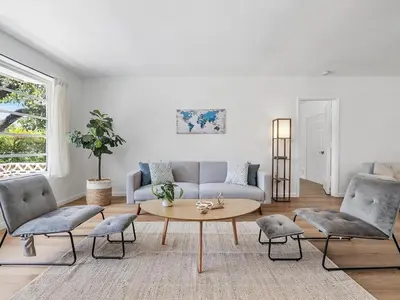 a living room with a couch and a table and chairs at 3BR Newly Renovated In Miami 15 Min To Beach in Miami