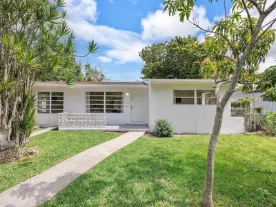 a white house with trees in front of it at 3BR Newly Renovated In Miami 15 Min To Beach in Miami