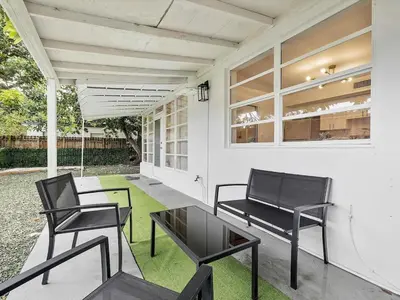 two chairs and a table on a porch at 3BR Newly Renovated In Miami 15 Min To Beach in Miami
