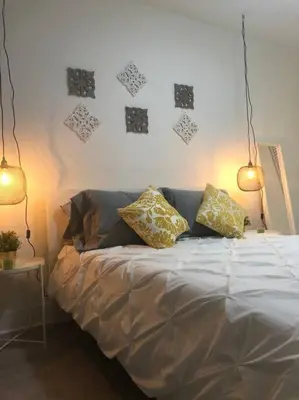 a bed with two pillows on it in a bedroom at CHIC AND MODERN APARTMENT STEPS FROM THE BEACH in Miami Beach