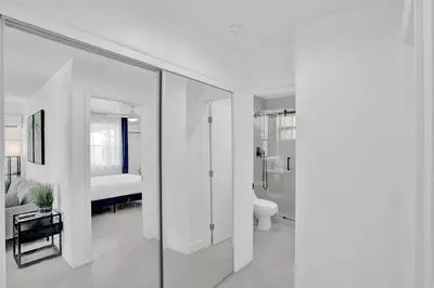 a white bathroom with a toilet and a shower at Hallandale Beach Modern apartment Chic Backyard in Hallandale Beach