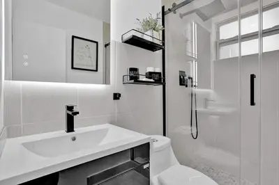 a white bathroom with a sink and a shower at Hallandale Beach Modern apartment Chic Backyard in Hallandale Beach
