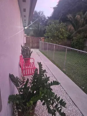 a red bench and a potted plant on a balcony at D&N Property Rental in Miami