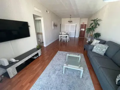 a living room with a blue couch and a television at Ocean view 1 bedroom in Hollywood in Hollywood