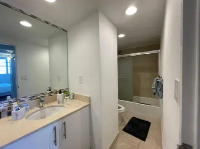 a bathroom with a sink and a toilet and a mirror at Ocean view 1 bedroom in Hollywood in Hollywood