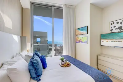 a bedroom with a bed with a large window at Ocean and Beach View Luxury Pet-Friendly in Hollywood