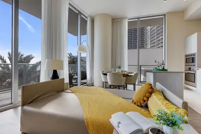 a bedroom with a large bed and a living room at Ocean and Beach View Luxury Pet-Friendly in Hollywood