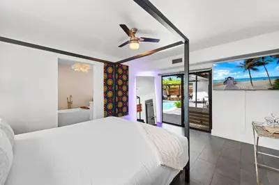 a bedroom with a bed and a ceiling fan at Casa Olan - Luxury Family Oasis 3BR North Miami Beach Villa with Saltwater Pool & Canal Views in Miami