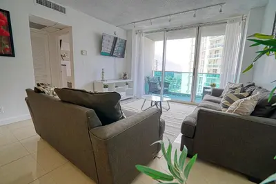 a living room with two couches and a large window at Amazing apartment by the Ocean in Hollywood