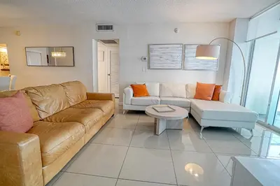 a living room with a couch and a table at Amazing apartment by the Ocean in Hollywood