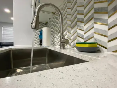a kitchen sink with a faucet on a counter at Rachaels Upscale 3 bedrooms Luxury Home in Fort Lauderdale