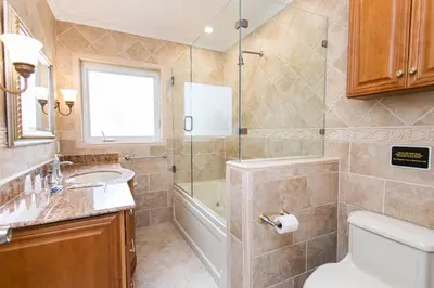 a bathroom with a sink and a toilet and a tub at Walk to Beach Luxury 5BR & 3BA Villa Hollywood Lakes in Hollywood