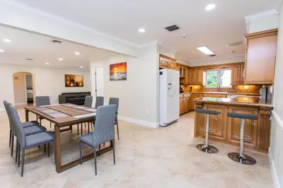 a kitchen and dining room with a table and chairs at Walk to Beach Luxury 5BR & 3BA Villa Hollywood Lakes in Hollywood