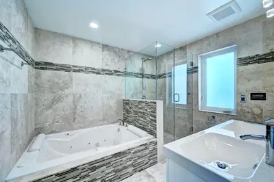 a large bathroom with a tub and a sink at Luxury 5BR & 3BA Villa Walk to Hollywood Beach in Hollywood