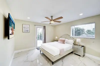 a bedroom with a bed and a ceiling fan at Luxury 5BR & 3BA Villa Walk to Hollywood Beach in Hollywood