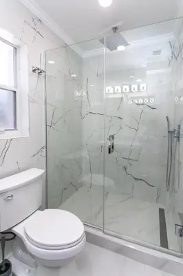 a white bathroom with a shower and a toilet at Fabulous 5BR & 3BA Villa near Hollywood Beach in Hollywood