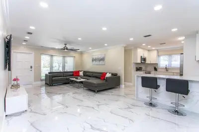 a large living room with a couch and a kitchen at Fabulous 5BR & 3BA Villa near Hollywood Beach in Hollywood