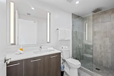 a bathroom with a toilet and a sink and a shower at Luxurious Unit in Miami in Miami