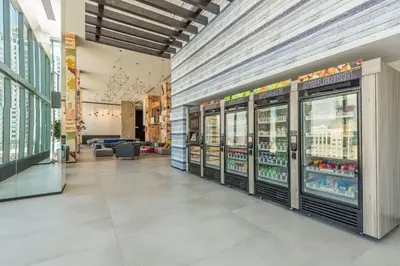 a store aisle with refrigerators in a store at Majestic unit in the heart of Downtown Miami in Miami