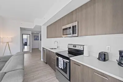 a kitchen with a couch and a stove top oven at Majestic unit in the heart of Downtown Miami in Miami