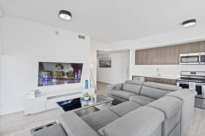 a living room with a couch and a tv at Majestic unit in the heart of Downtown Miami in Miami