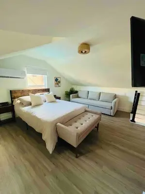 a large bedroom with a large bed and a couch at La Casita in Miami